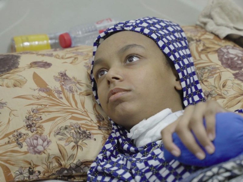 A child in Gaza with a head wound receives care in Al-Aqsa Martyrs' Hospital in Deir al-Balah. Still from video by